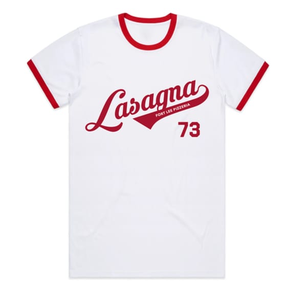 White t-shirt with red trim, featuring "Lasagna Fort Lee Pizzeria 73" in red script.