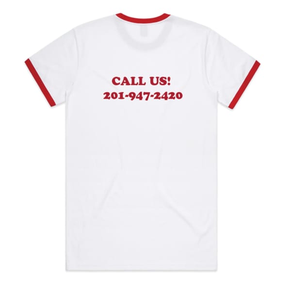Back of a white t-shirt with red trim, displaying "CALL US! 201-947-2420" in red text.